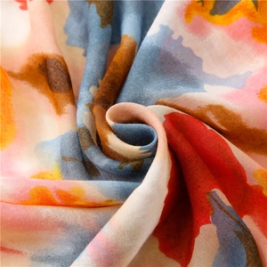 Detailed macro shot of modern watercolor floral print scarf with soft fringe edges