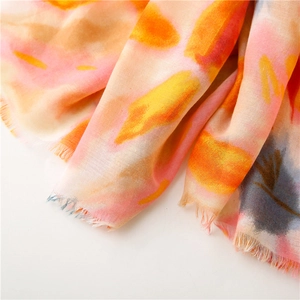 Detail of colorful watercolor floral scarf with natural frayed edges and soft texture