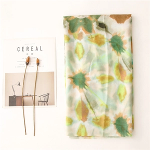 Artistic floral watercolor print scarf with fringe edges and lightweight texture