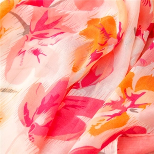 Macro detail of breathable peach floral print scarf showing lightweight fabric texture