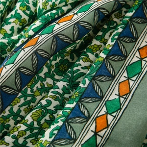 Detailed macro shot of floral and geometric prints on cotton-linen shawl fabric