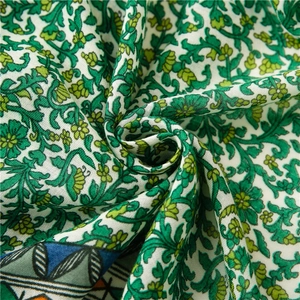Detailed macro view of soft floral cotton linen fabric with green and yellow pattern details