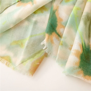 Detailed view of colorful abstract print scarf with soft frayed edges and breathable texture