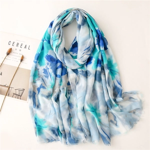 Close-up of abstract blue and white floral scarf with soft frayed edges detail