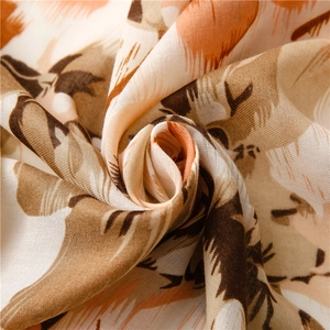 Detailed texture of lightweight floral cotton linen scarf with abstract feather prints