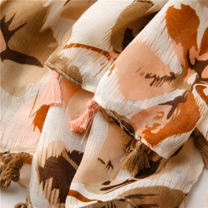 Close-up of lightweight floral cotton linen scarf with soft fringe and sheer texture