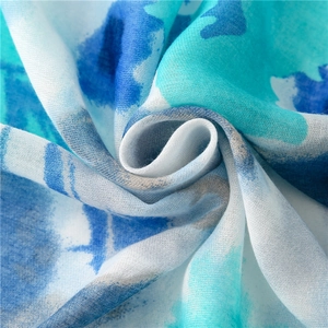 Macro view of blue and white watercolor print fabric with detailed woven texture