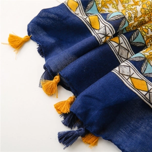 Detail of navy cotton linen scarf with ethnic floral patterns and colorful tassels