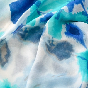 Detail shot of lightweight floral scarf showing soft fabric texture and blue watercolor print