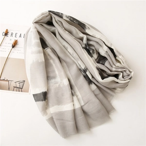 Close-up of abstract ink-wash pattern on cotton-linen scarf with fine fringe edges