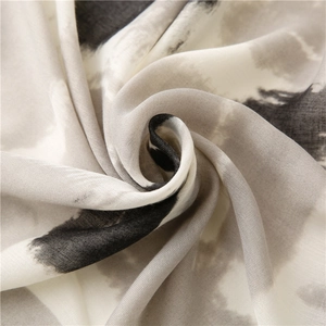 Macro detail of abstract ink wash pattern on a soft geometric cotton linen shawl scarf