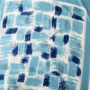 Detail of blue abstract geometric cotton linen scarf with fine edge stitching texture