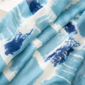 Detailed texture of blue and white abstract cotton linen scarf with soft natural folds