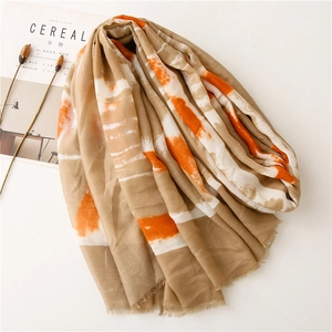 Close-up of abstract geometric cotton linen scarf with soft fringe and artistic dye patterns