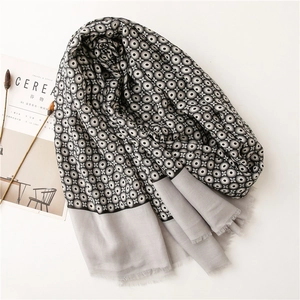 Grey linen scarf with black and white circle patterns and elegant fringe trim