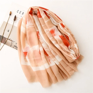 Detail of abstract tie-dye cotton linen scarf with frayed edges and soft texture