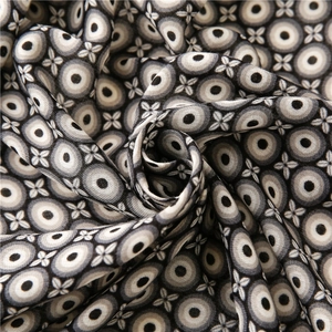 Detailed close-up of circular geometric print on soft cotton linen scarf with fringe
