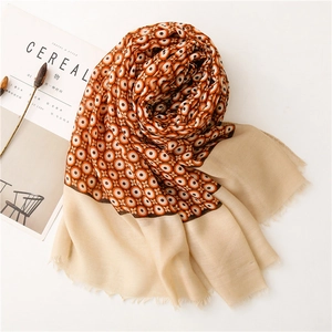 Close-up of bohemian linen scarf with geometric circle patterns and delicate frayed edges