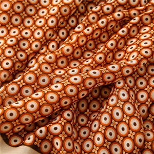 Detail of vintage geometric ring pattern on soft linen-cotton blend scarf fabric