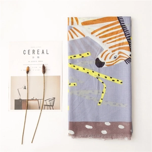 Artistic zebra print scarf with orange patterns, purple base, and fringe edge details