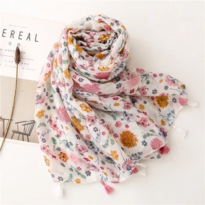 Close-up of floral print voile scarf with colorful flowers and pink tassel edge details