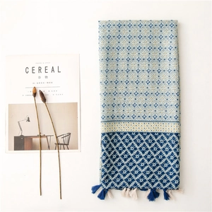 Bohemian blue and white patterned cotton linen scarf with tassels on neutral background