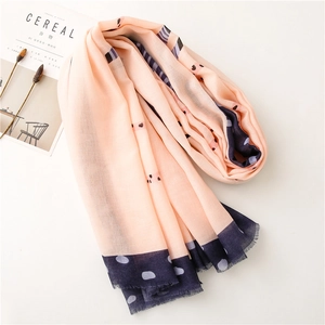 Detail of cotton linen scarf with pink orange color block and delicate fringe edge