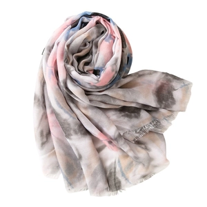 Women's long scarf with colorful abstract floral print and fringe edges on white background
