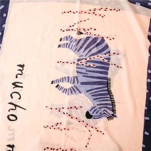 Detailed view of zebra print scarf with pink base, blue stripes and polka dot edges