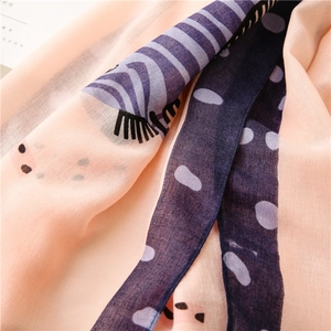 Detail of peach cotton linen scarf showing zebra print and soft fabric texture