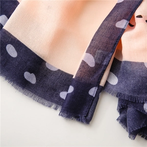 Detail of thin cotton linen scarf showing pink texture, blue edge and fine fringe