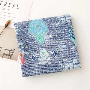 Detail of bohemian floral pattern on soft cotton-linen scarf with twill texture