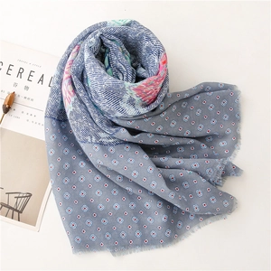 Detail of blue paisley floral print shawl with soft texture and delicate fringe edge