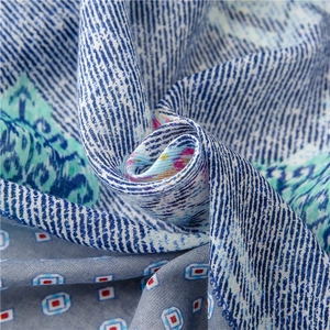 Detailed macro view of soft navy blue paisley floral pattern fabric with silky texture