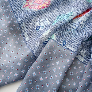 Close-up of soft floral paisley and geometric pattern stitching on lightweight scarf