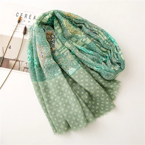 Detail of forest green paisley scarf with soft texture and ethnic geometric patterns