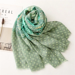 Detail of green paisley cotton linen shawl with geometric print and fringe edges