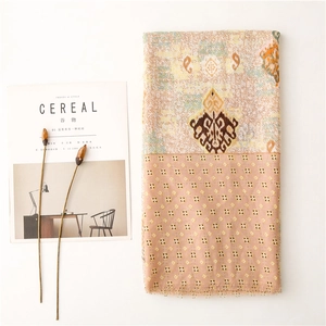 Detail of bohemian paisley shawl with soft fringe texture and ethnic pattern design