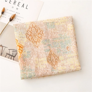 Detailed view of paisley pattern scarf with soft cotton-linen texture and fringe