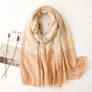 Detailed flat lay of soft cotton linen scarf with ethnic patterns and frayed edges
