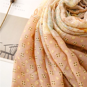 Close-up of soft cotton-linen scarf featuring vintage geometric patterns and warm tones