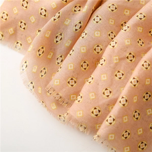 Detail of soft cotton scarf with vintage geometric patterns and frayed tassel edges