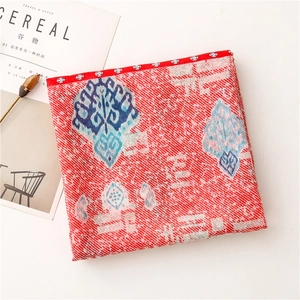 Detail of red paisley pattern cotton linen scarf with folk geometric jacquard texture