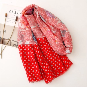 Detail of red paisley cotton scarf with delicate fringe edges and geometric patterns