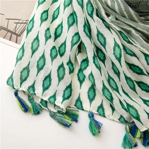 Detail of vintage geometric floral print scarf with tricolor tassel fringe accents