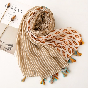 Detailed close-up of retro floral print scarf with bohemian tassels and soft fabric texture