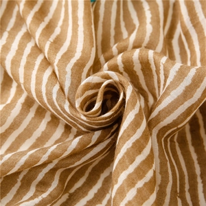 Detailed macro view of the soft cotton-linen fabric texture with brown and white stripes
