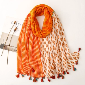 Close-up of bohemian floral geometric cotton scarf with colorful tassel edge detail