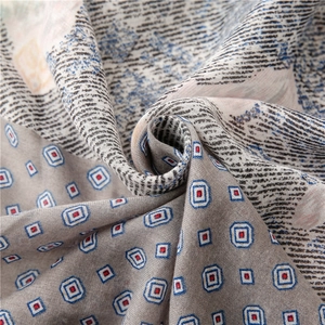 Macro shot of paisley pattern scarf showing soft cotton texture and fringed fabric weave