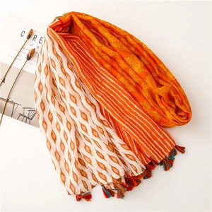 Detailed shot of retro floral patterns and colorful tassels on a cotton linen scarf